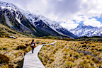 Hike the Hooker Valley Track. This incredible three-hour return walk offers some of the highest reward-to-effort ratios of any hike in the country - no mountaineering expertise needed. The flat, well-maintained trail leads you across three spectacular swing bridges and through an alpine valley flanked by the Southern Alps. It ends at a glacial lake sitting directly beneath the towering, snow-capped peak of Aoraki (Mount Cook).