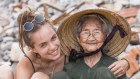 A young tourist takes the time to hug an elderly worker in the fishing village of Bai Xep in Vietnam.