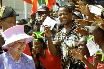 The Queen smiles to waving crowds in Jamaica, part of her Golden Jubilee tour.