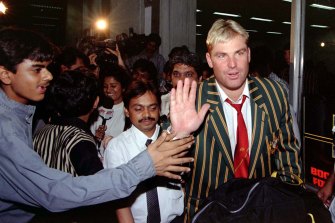 A cricket fan tries to shake hands with Shane Warne after the Australian team’s arrival at Mumbia airport in 1998. 