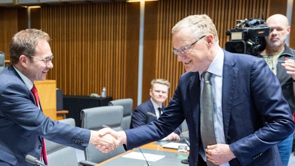 Daniel Mulino, left, greets RBA governor Philip Lowe at an economics committee hearing. The committee has put the bank on notice to take into account supply-chain issues in its interest rate decisions.