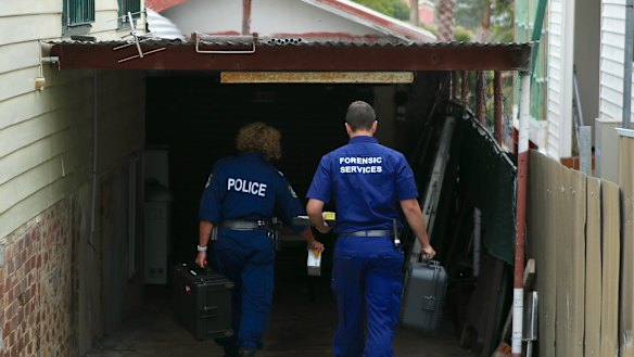 Forensic police arrive at the Woonona property on Tuesday. 