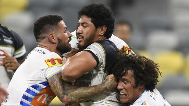 Jason Taumalolo of the Cowboys is tackled by Nathan Peats and Kevin Proctor of the Titans during their match last Friday in Townsville.