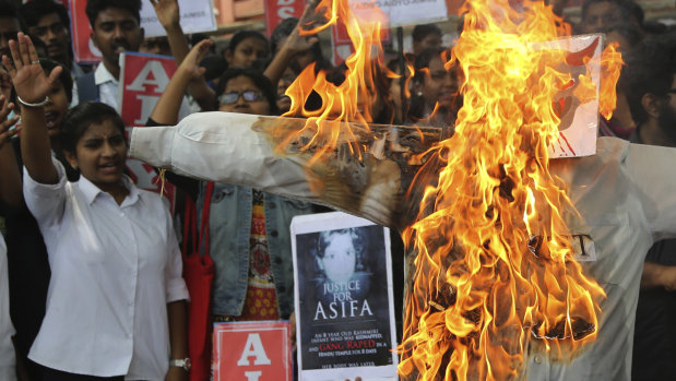 Members of a student  organisation shout slogans next to a burning effigy representing one of the men who is accused of the rape and murder of eight-year-old Asifa, during a protest in Bangalore, India, on Friday.