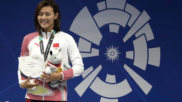 World beater: Liu Xiang after receiving her gold medal.