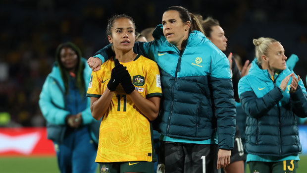 Mary Fowler of Australia is embraced by Lydia Williams as players of Australia applaud the fans after defeat to England.