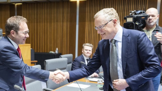 Daniel Mulino, left, greets RBA governor Philip Lowe at an economics committee hearing. The committee has put the bank on notice to take into account supply-chain issues in its interest rate decisions.