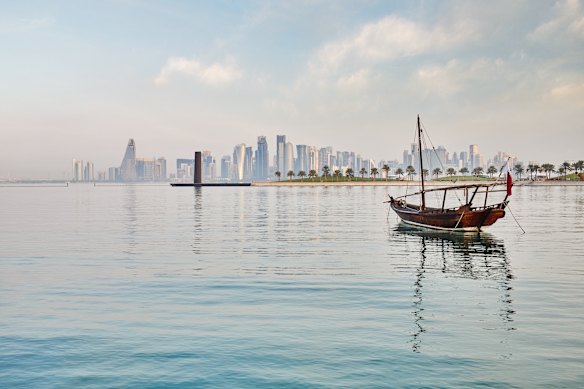 A dhow sails on the harbour.