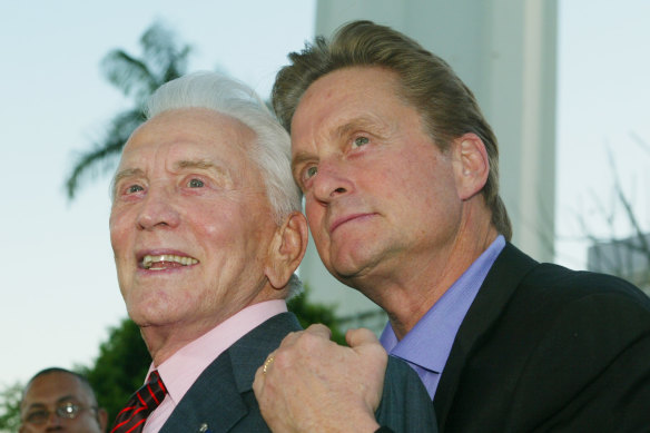 Actor Kirk Douglas poses with his son Michael Douglas at the Los Angeles premiere of their film It Runs in the Family in 2003. 