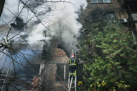 Firefighters work to put out a fire after two residential buildings were hit in the Pecherskyi district in Ukraine’s capital Kyiv.