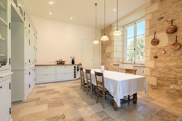 The renovated Château de La Roche-Joubert’s kitchen with cabinets by French artisan Simon Contamine. 
