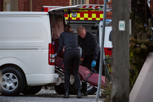 A body is removed from the site of a fatal building fire on the corner of Probert and Albermarle streets in Newtown. 