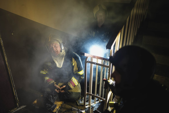 Firefighters work to put out a fire after two residential buildings were hit in the Pecherskyi district in Ukraine’s capital Kyiv as nationwide air alerts sounded across the country on November 15.
