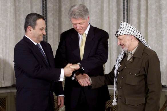 President Bill Clinton joins the hands of Israeli Prime Minister Ehud Barak (L) and Palestinian President Yasser Arafat (R) during the peace talks that led to the Oslo Accords. 