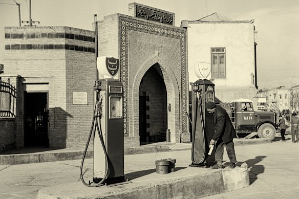 A man at a petrol pump, supplied with Iranian oil, in Tehran in 1948.