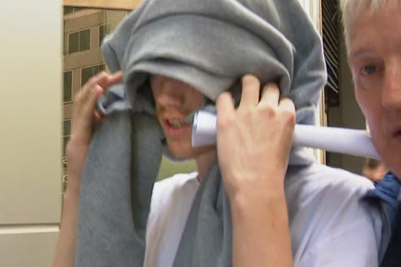 Connor Mathiasson covers his head as he leaves Melbourne Magistrates’ Court on Tuesday.