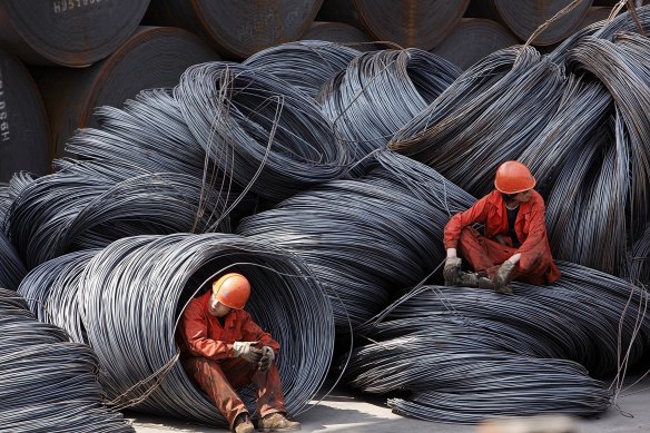 Workers take a break at a stockyard in Shanghai. Demand for Australian iron ore has held up well despite tensions between the two countries.