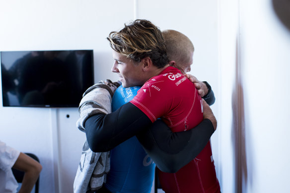 Julian Wilson hugs Mick Fanning after Fanning was attacked by a shark at the JBay Open.