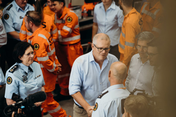 Prime Minister Scott Morrison, pictured with SES workers during the NSW floods, says the new national agency will help communities rebuild and strengthen their ability to deal with future disasters.