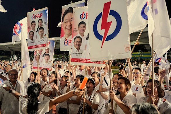 Supporters of the ruling People’s Action Party at an assembly point on election in Singapore in May. 

