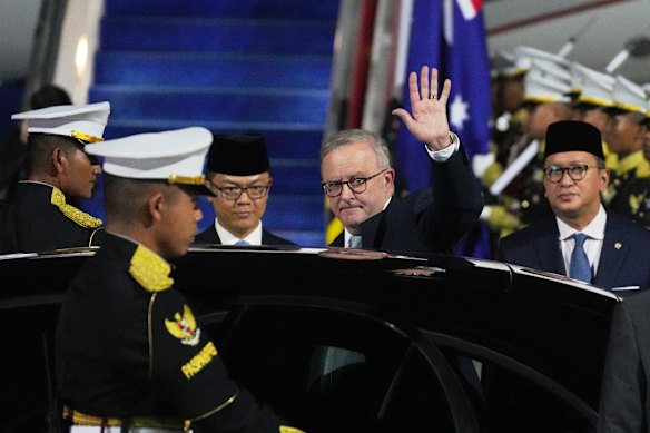 Australian Prime Minister Anthony Albanese waves to journalists upon his arrival at Halim Perdanakusuma air base in Jakarta, Indonesia. 
