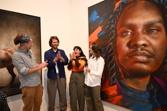 Packers Timothy Dale, Monica Rudhar and Alexis Wildman with artist Matt Adnate (second from left), who has won the Archibald Packing Room Prize for his portrait of Baker Boy.