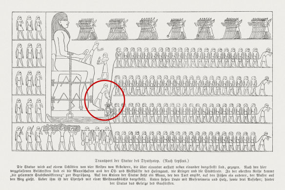 The man in the red circle wets sand to help move a giant statue while building the tomb of Djehutihotep in 1900BC.  
