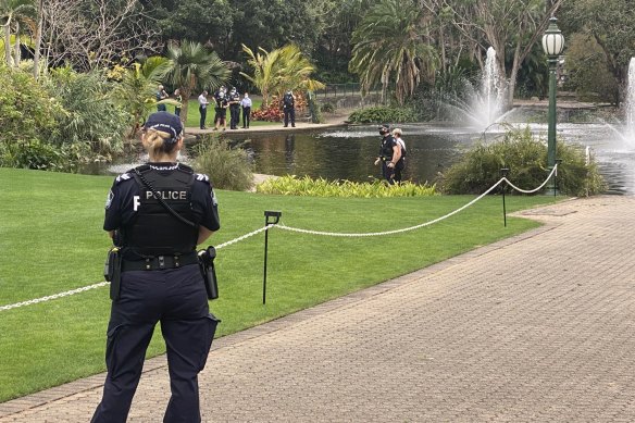 Police at the Brisbane Botanic Gardens, where the body was found in a pond.