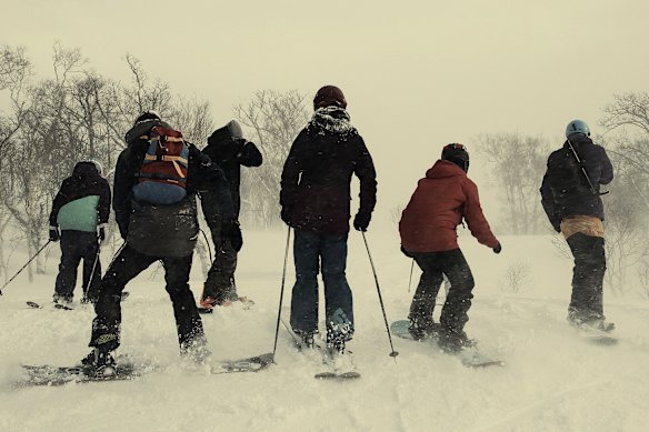 Skiers and snowboarders in Kutchan, Hokkaido. Nearly a million Australians visited Japan in 2024, many bound for the snowfields. 