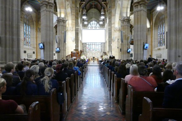 Mourners gather to watch the service for Lilie James on a live stream in St Andrew’s Cathedral.