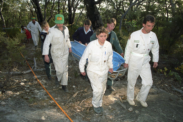 Rescue workers remove the body of a female British backpacker after it was discovered in the Belanglo State Forest on September 20, 1992. 