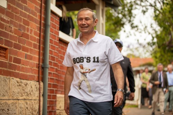 Roger Cook dons a Bob Hawke’s 11 shirt at Hawke’s former home.