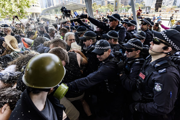 Protesters and police clash outside a mining conference in Melbourne in 2019. 