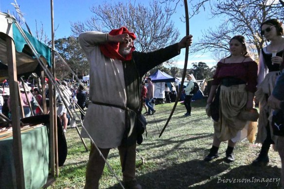 Richard Halcomb demonstrates the technique of firing a bow and arrow.