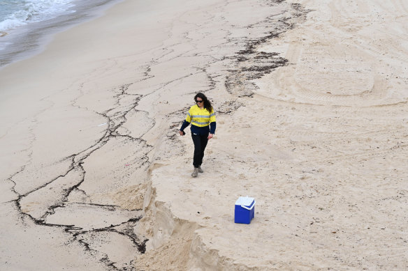 Coogee Beach is closed after mysterious dark balls washed ashore on Tuesday.