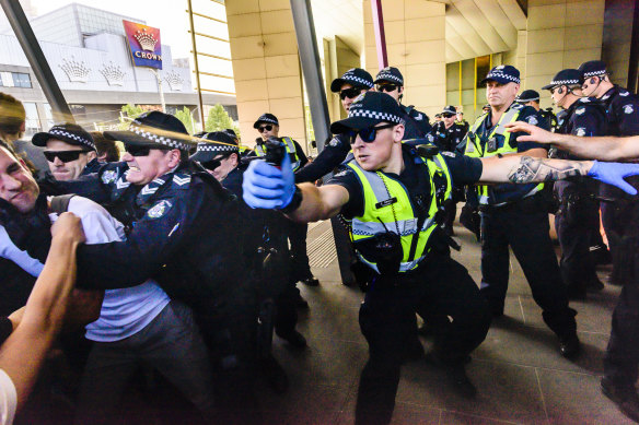 A police officer uses capsicum spray at the 2019 protest in Melbourne.