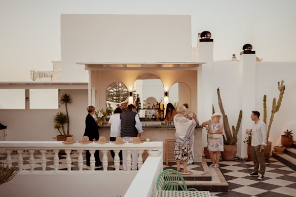 Guests enjoy sunset drinks on the roof.