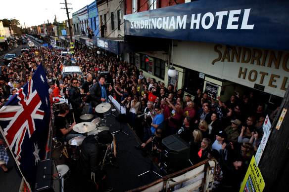Former Angels frontman Doc Neeson plays at the Save Our Sando rally outside the Sandringham in 2012. He died in 2014.