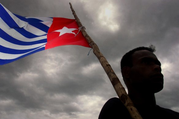 A Papaun holds the Morning Star independence flag.