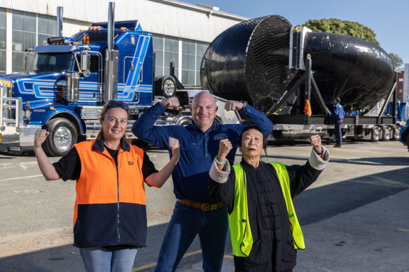 Brisbane artist Lindy Lee (right) with her sculpture Ouroborus on its way to the National Gallery of Australia.