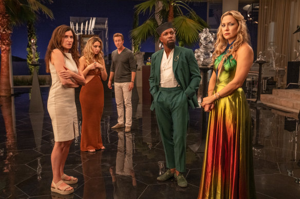 The characters in Glass Onion, (from left) Kathryn Hahn as Claire, Madelyn Cline as Whiskey, Edward Norton as Myles, Leslie Odom Jr as Lionel, and Kate Hudson as Birdie, are similar to the greedy twits found in Agatha Christie’s mysteries.