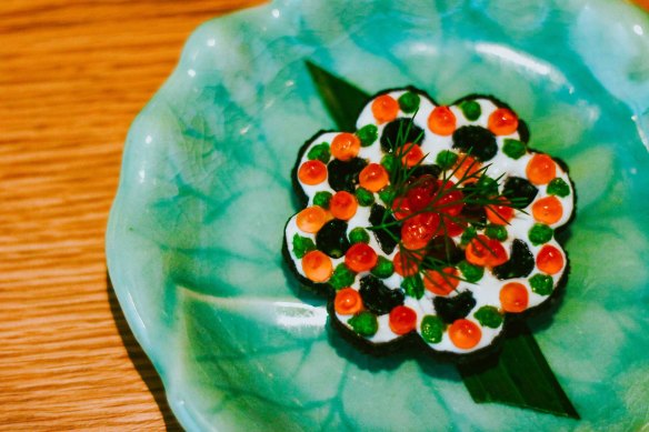 A savoury twist on sweet treat Banh Nhung, featuring salmon mousse, creme fraiche, dill cream and salmon roe.