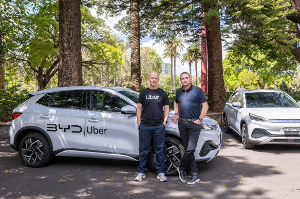 Uber Australia general manager Dom Taylor and EVDirect chief executive Luke Todd with a BYD electric vehicle. 