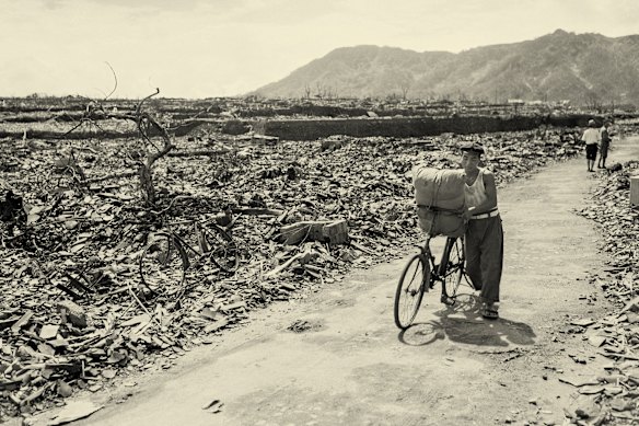 A man pushes his bicycle through the devastation in Nagasaki after the US dropped a nuclear bomb on the Japanese city in 1945, 