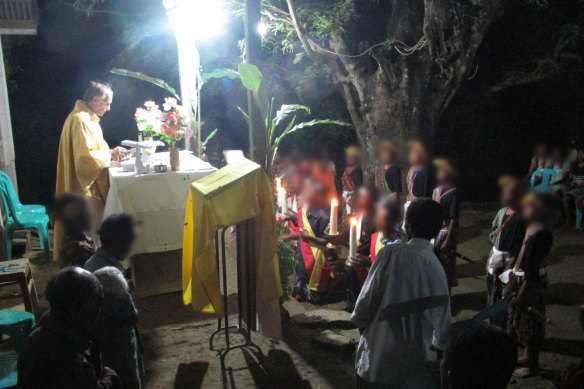 Richard Daschbach holds a Christmas eve mass at the shelter.