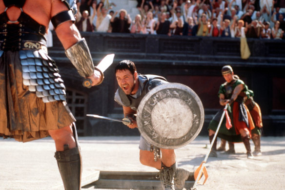 People doing extraordinary things: Russell Crowe (centre, the Rabbitohs’ co-owner) fights a gladiator in his role as Roman general Maximus.
