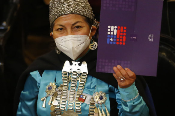Mapuche activist and former president of the Constitutional Convention Elisa Loncon shows the draft of the new Chilean constitution, a year after its authors met for the first time.