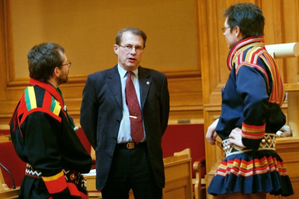 Two unidentified Samis in traditional dress talk to then-speaker of the Swedish parliament Per Westerberg, centre, as the Sami Parliament convened in Stockholm in 2004. The Samis gained their right to a governing body of their own in the 1980s. 