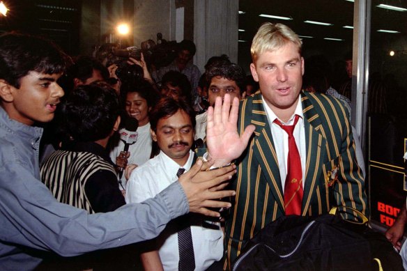 A cricket fan tries to shake hands with Shane Warne after the Australian team’s arrival at Mumbia airport in 1998. 