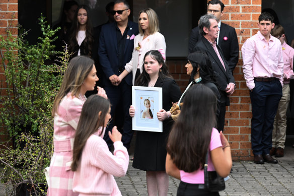 Family and friends wear pink at Charlotte’s funeral. 